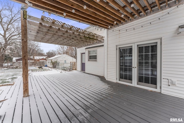 snow covered deck with french doors