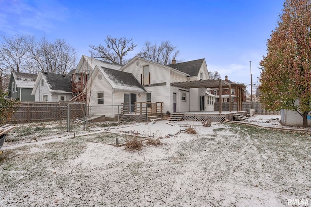 snow covered rear of property featuring a pergola and a deck