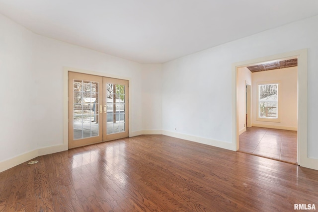 unfurnished room with wood-type flooring and french doors