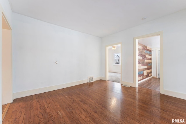 spare room with dark hardwood / wood-style floors