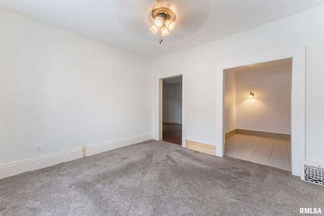 unfurnished bedroom with ceiling fan and light carpet