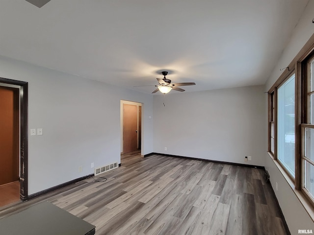 spare room with ceiling fan and light hardwood / wood-style floors