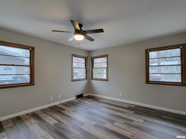 spare room featuring hardwood / wood-style floors and ceiling fan