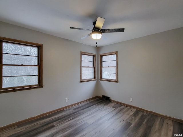 unfurnished room featuring ceiling fan and dark wood-type flooring