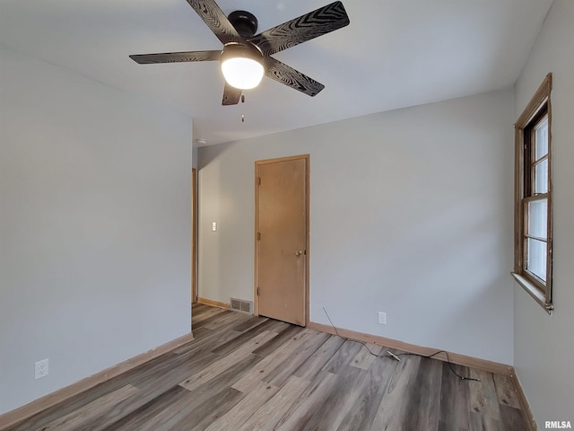 spare room featuring light hardwood / wood-style floors and ceiling fan