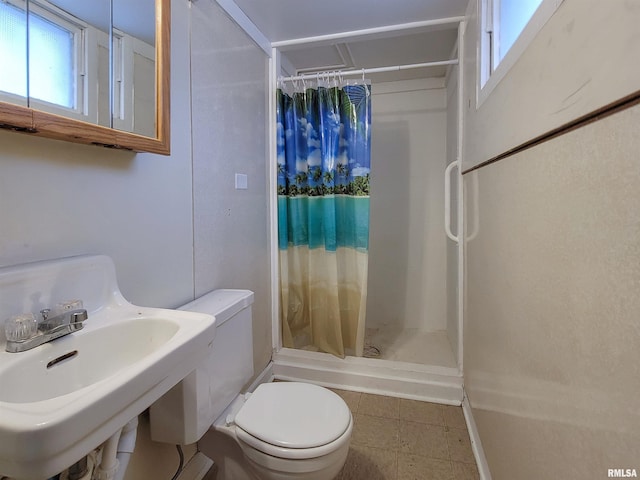 bathroom with toilet, sink, and walk in shower