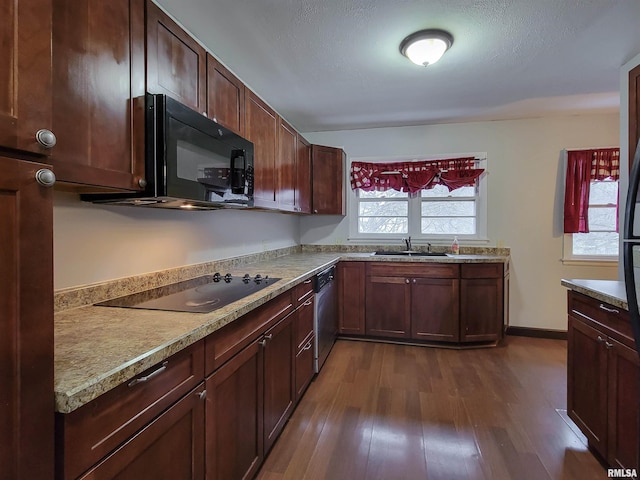 kitchen with dark wood-type flooring, black appliances, a textured ceiling, and sink