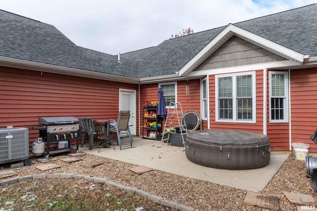 back of house with central air condition unit and a patio