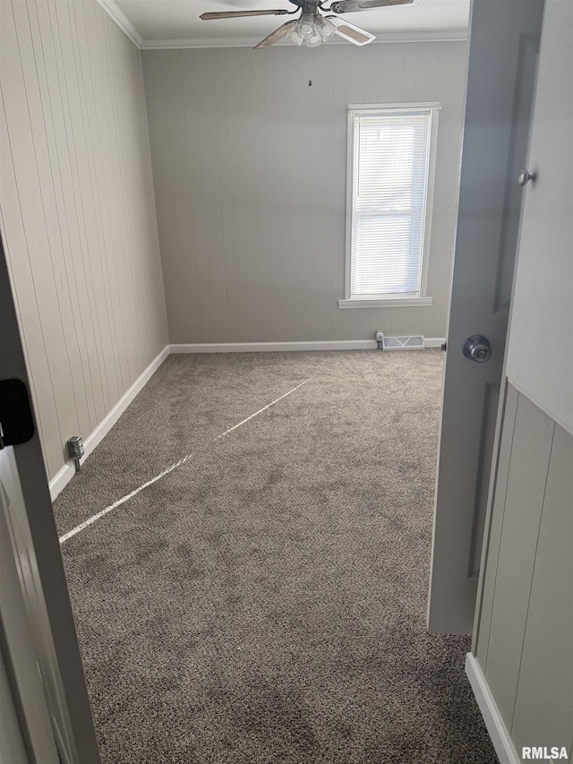 unfurnished room featuring crown molding, ceiling fan, and carpet flooring