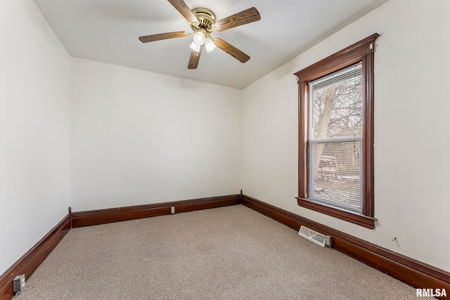 carpeted empty room with ceiling fan