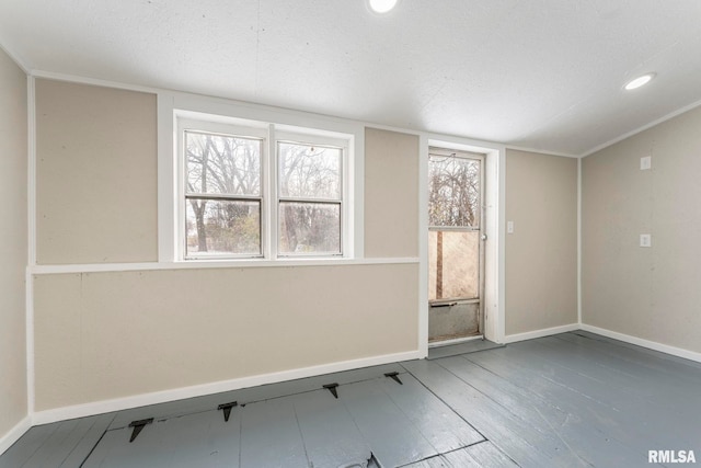 spare room with wood-type flooring and a textured ceiling