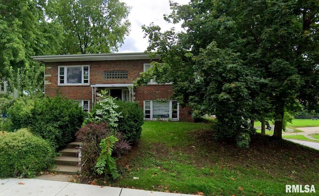 split foyer home featuring brick siding