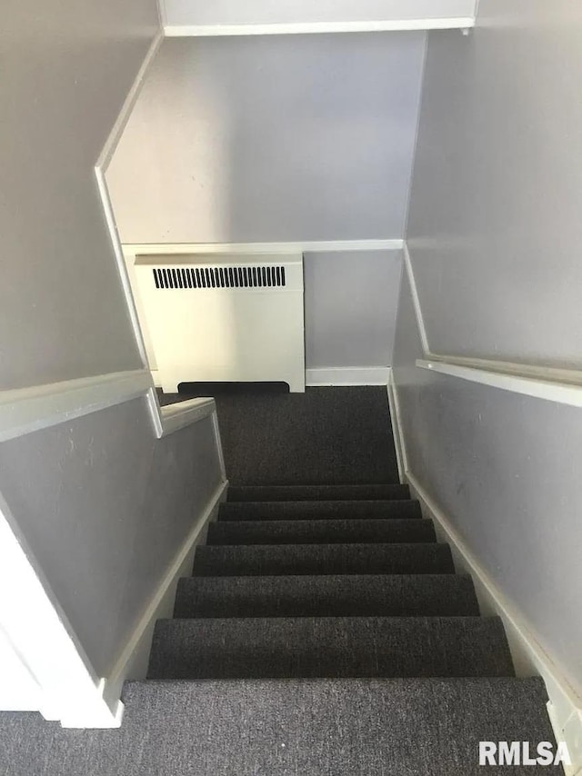 staircase featuring radiator