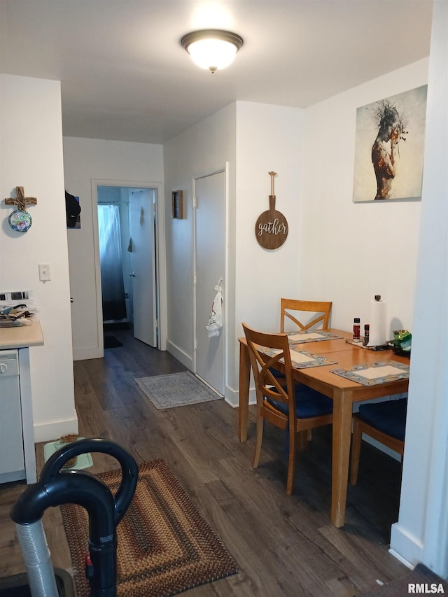 dining space featuring baseboards and dark wood-type flooring