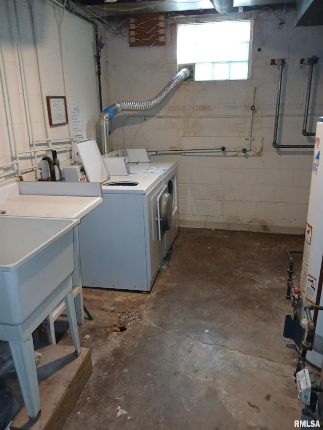 below grade area featuring washing machine and dryer and concrete block wall