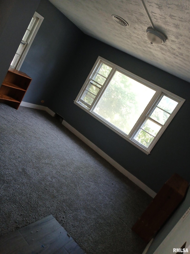 interior space featuring carpet flooring and baseboards