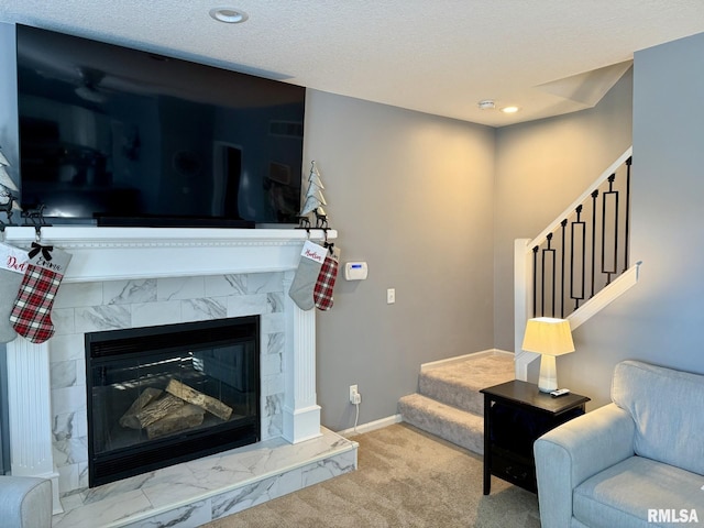 living room with a high end fireplace and light colored carpet