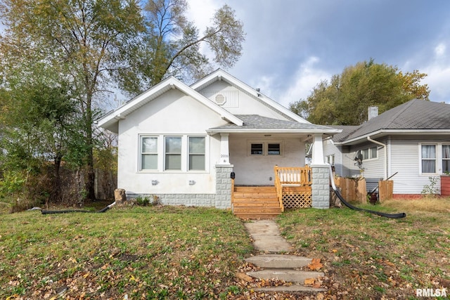 bungalow-style home with a porch and a front lawn