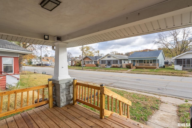 wooden terrace with a porch