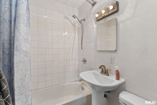 bathroom featuring toilet and shower / tub combo with curtain