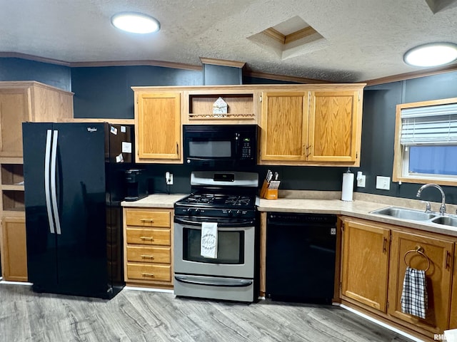 kitchen with sink, crown molding, a textured ceiling, vaulted ceiling, and black appliances