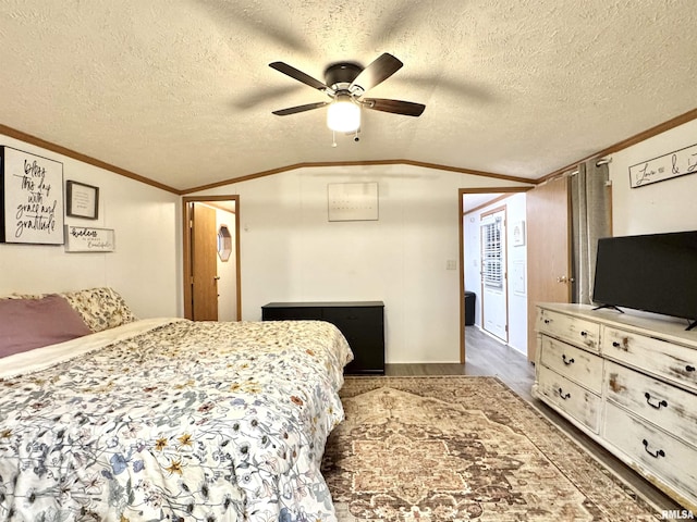 bedroom featuring dark hardwood / wood-style flooring, ornamental molding, a textured ceiling, ceiling fan, and lofted ceiling