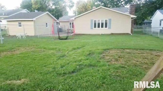 rear view of house with a yard