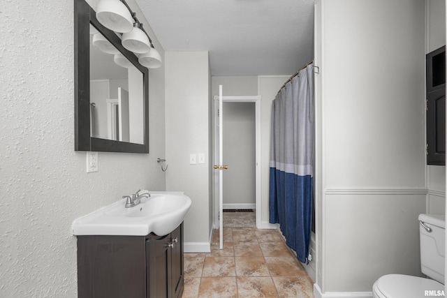 bathroom featuring a textured ceiling, vanity, toilet, and a shower with curtain