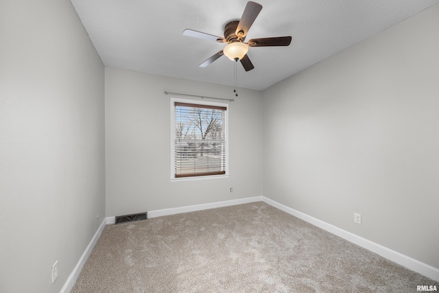 empty room featuring carpet floors and ceiling fan