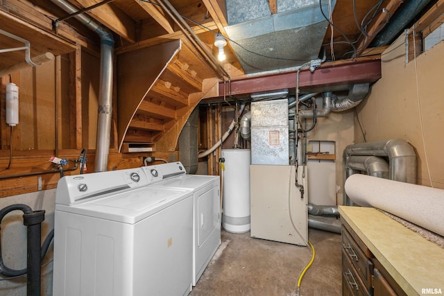 clothes washing area with washer and clothes dryer and water heater