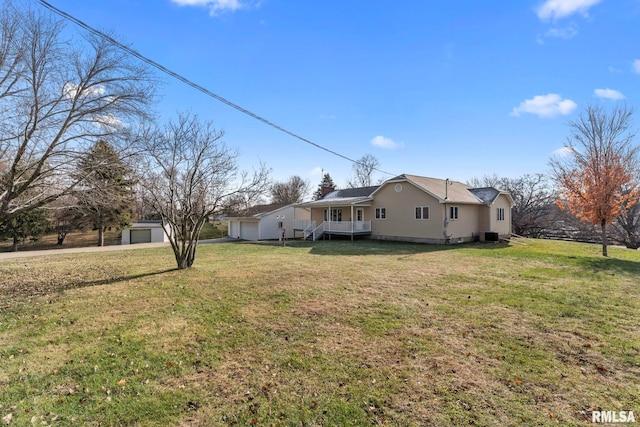 view of yard with a porch and a garage