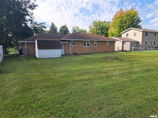 rear view of property featuring a yard