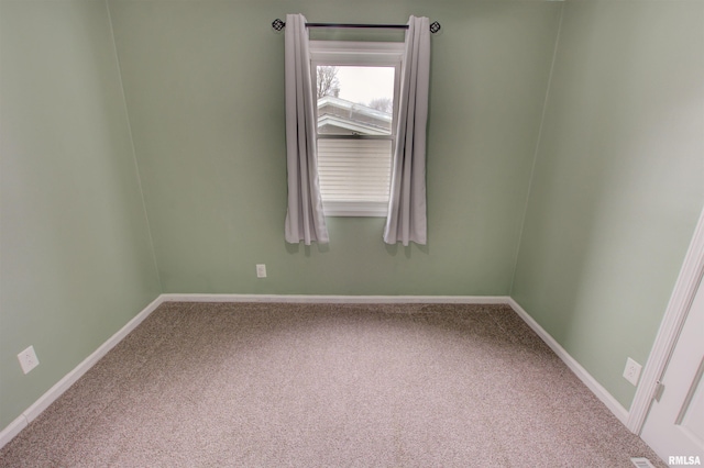 spare room with carpet flooring and baseboards