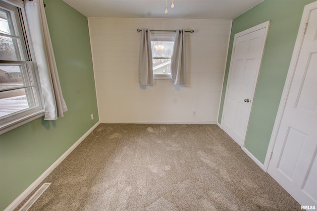 unfurnished bedroom featuring baseboards and carpet flooring