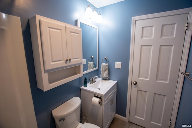 bathroom featuring vanity and toilet