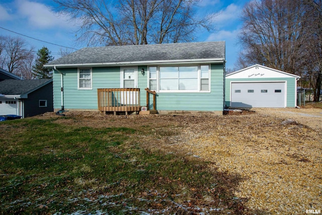 view of front of property featuring a garage, an outbuilding, and a front yard