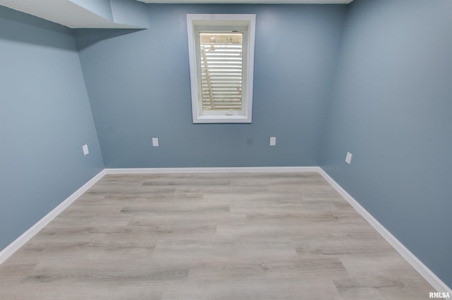 unfurnished room featuring wood finished floors and baseboards