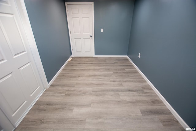 unfurnished room featuring wood finished floors and baseboards