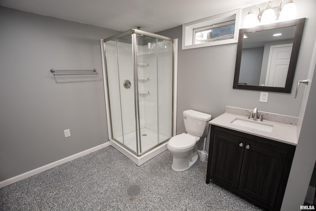 bathroom featuring a shower stall, toilet, vanity, and baseboards