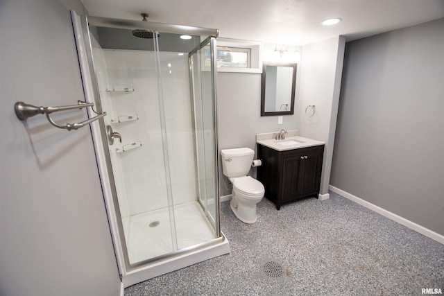 bathroom featuring baseboards, toilet, a stall shower, vanity, and speckled floor