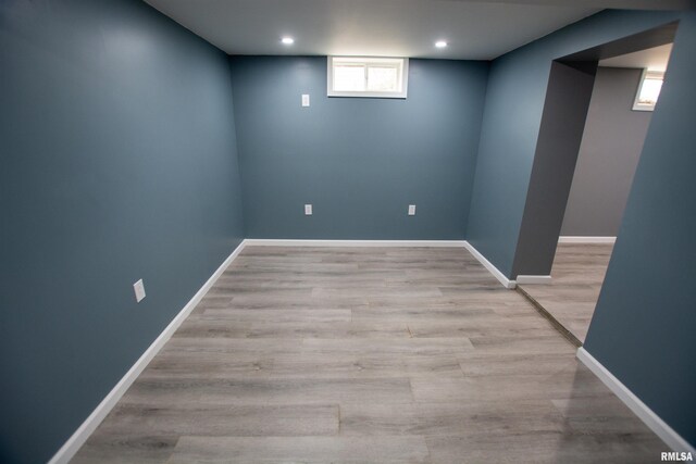 below grade area featuring recessed lighting, light wood-style floors, and baseboards