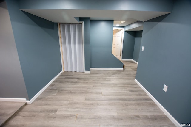 finished basement with wood finished floors and baseboards