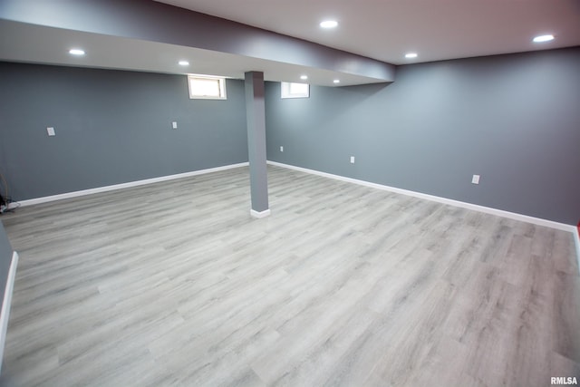 below grade area with recessed lighting, baseboards, and light wood-style floors