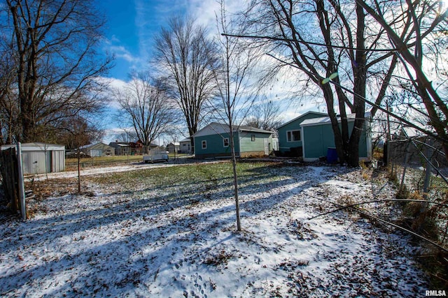 yard covered in snow with an outdoor structure