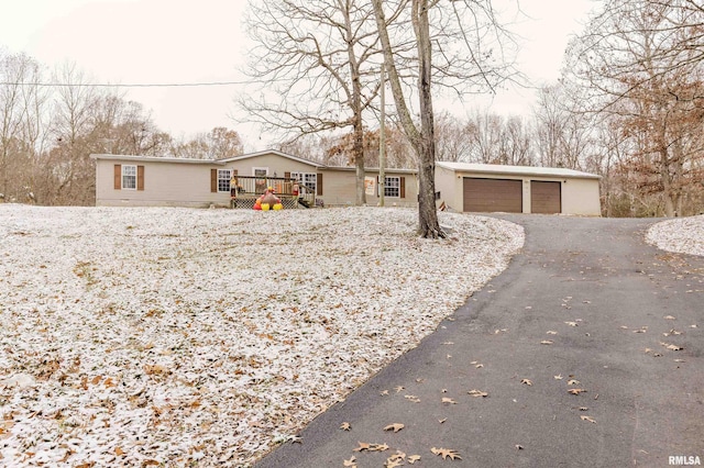 view of front of house featuring a garage, an outdoor structure, and a wooden deck