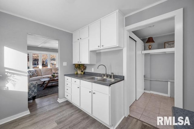 kitchen featuring sink, white cabinets, and light hardwood / wood-style flooring