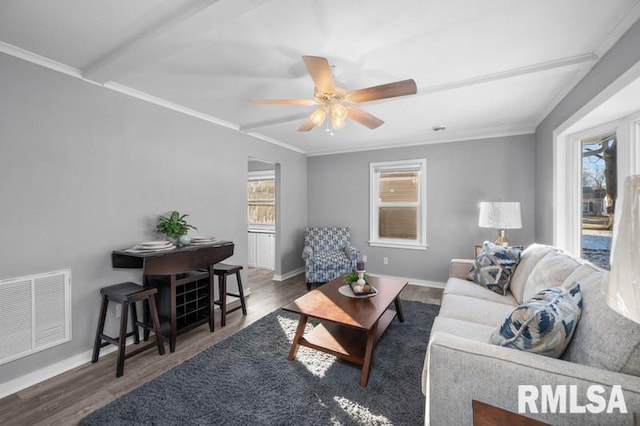 living room featuring dark wood-type flooring, crown molding, and ceiling fan