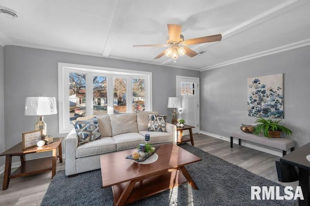 living room featuring ceiling fan, ornamental molding, and hardwood / wood-style flooring