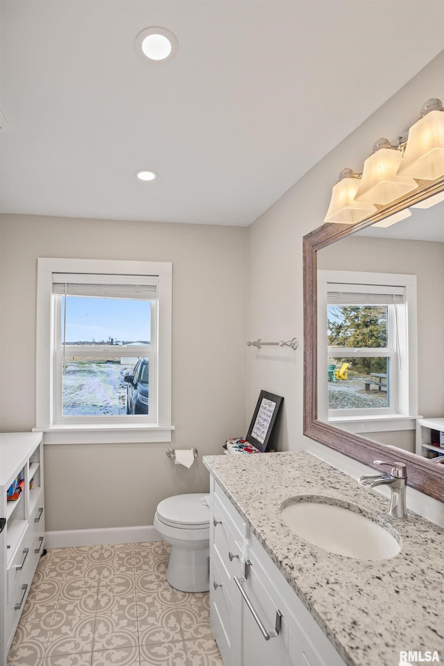 bathroom with tile patterned floors, vanity, and toilet