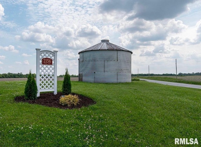 view of outbuilding featuring a yard